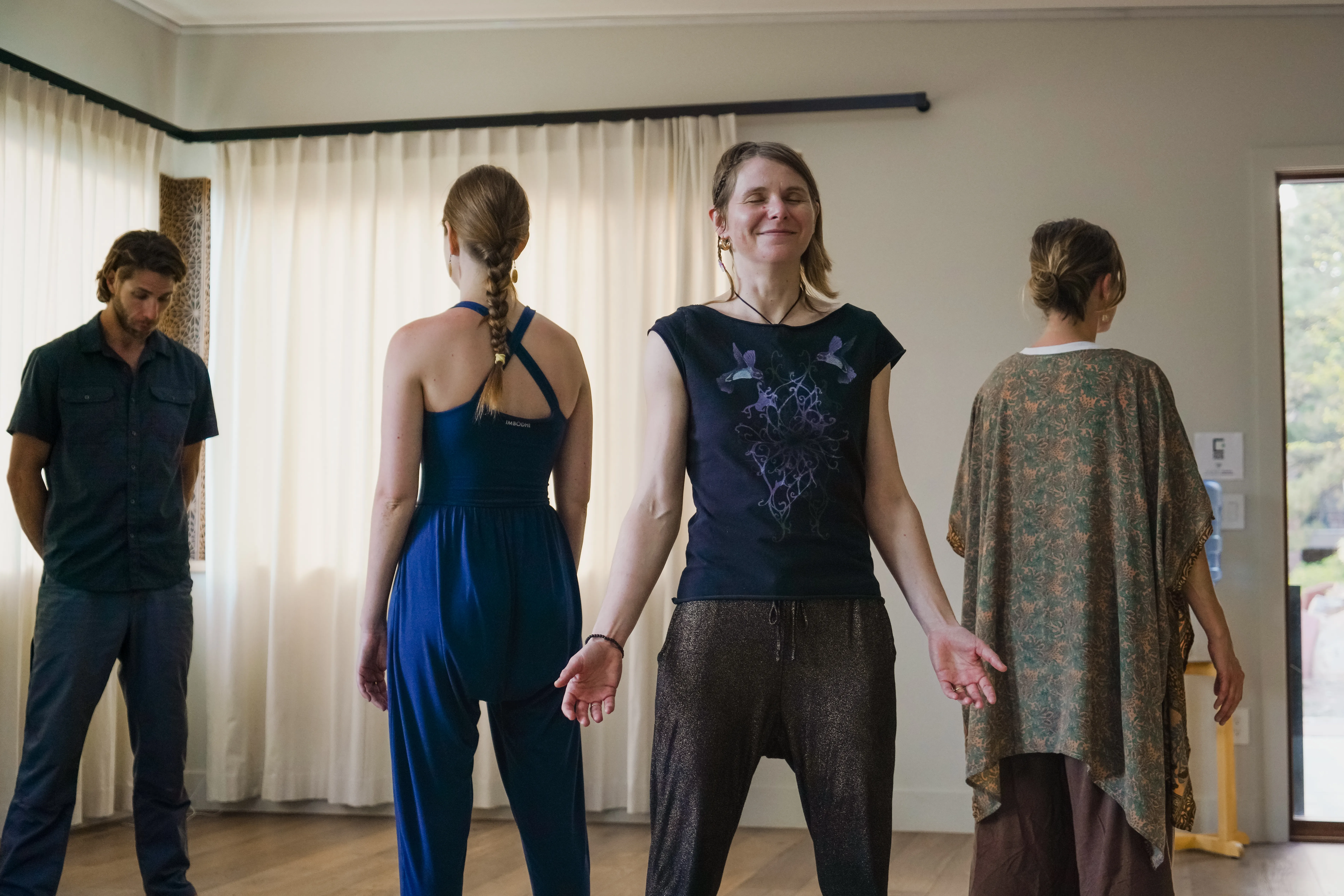 Participants standing in embodied practice at a Sacred Edge evening