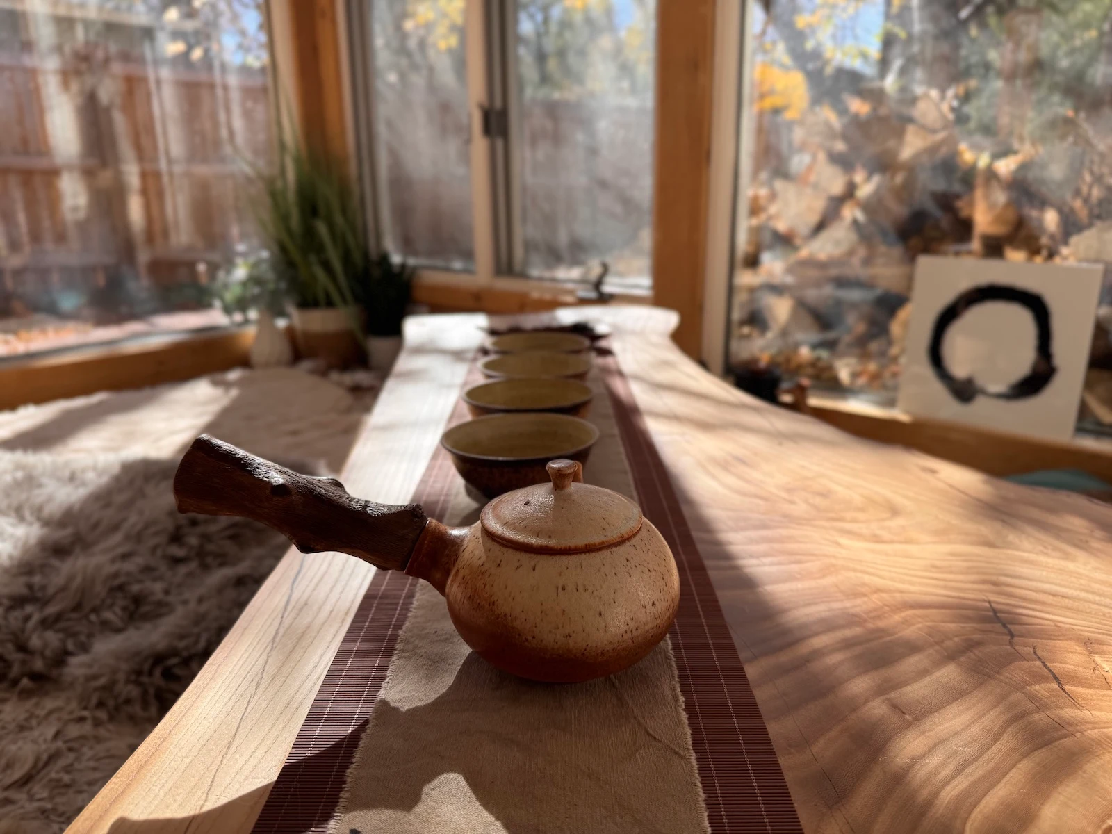 A simple tea ritual — teapot and cups on a wooden table